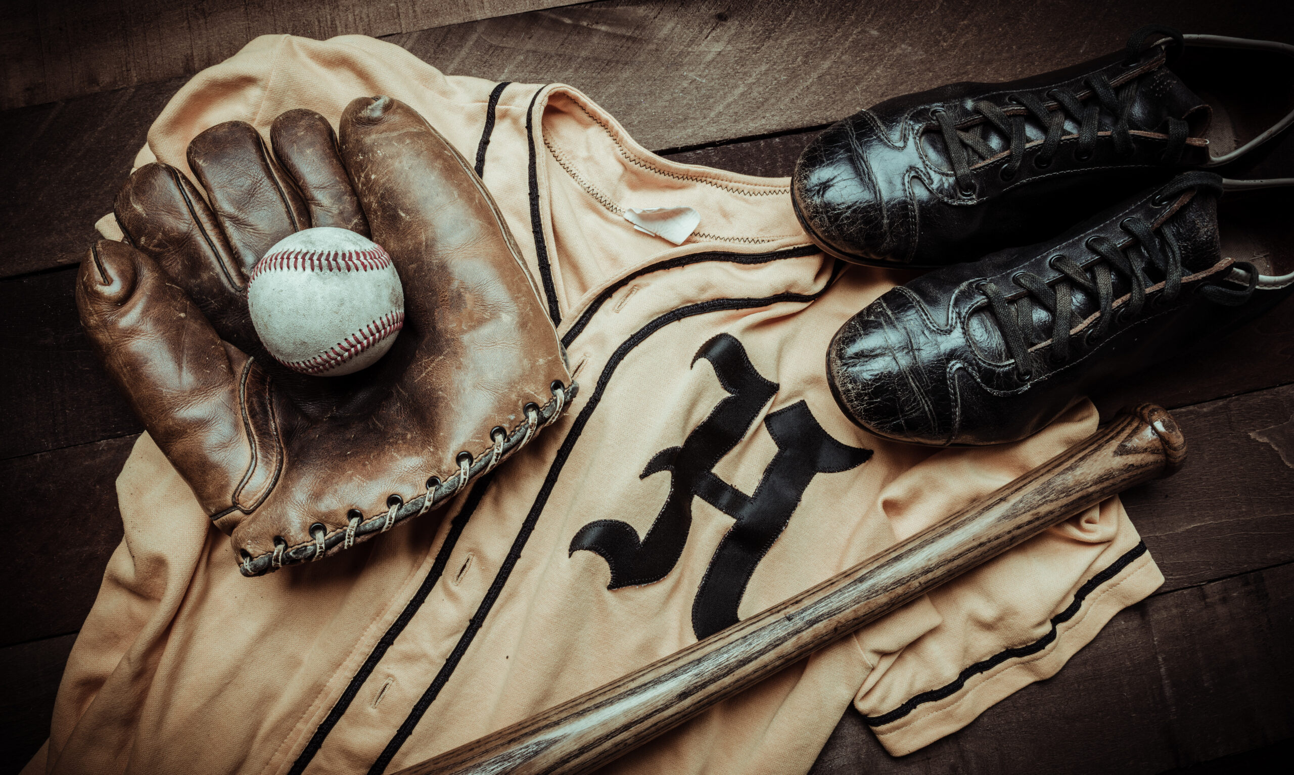 Vintage baseball gear on a wooden background The LockwoodMathews