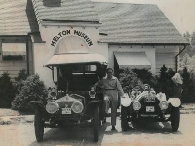 James Melton outside the Melton Museum (Norwalk, Conn.) standing between his 1907 Rolls Royce and 1914 Mercer Raceabout.